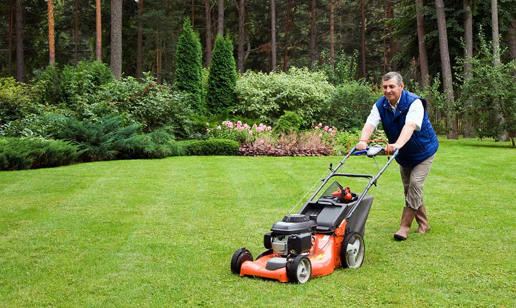 technician mowing the lawn